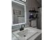 Modern bathroom with a large illuminated mirror and floating shelves at 9302 E Broadway Rd # 184, Mesa, AZ 85208