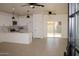 Bright, open-concept living area with tile floors, modern lighting, and sliding glass doors to the patio at 11125 W Torren Dr, Arizona City, AZ 85123