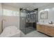 Elegant bathroom with a walk-in shower, a luxurious soaking tub, and double sinks at 1323 W Tuckey Ln, Phoenix, AZ 85013