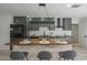 Kitchen with an island, barstool seating, and sage green cabinetry at 1323 W Tuckey Ln, Phoenix, AZ 85013