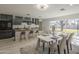Open-concept living space with a kitchen, dining area, and sliding glass doors to the yard at 1323 W Tuckey Ln, Phoenix, AZ 85013
