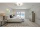 Well-lit main bedroom with a large window, a sliding glass door, and a light-colored wood floor at 1323 W Tuckey Ln, Phoenix, AZ 85013