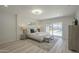 Bright main bedroom features light wood floors and a sliding glass door leading to the backyard swimming pool at 1323 W Tuckey Ln, Phoenix, AZ 85013