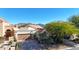 Tan house exterior with garage, landscaping, and mountain backdrop at 23635 N 75Th Pl, Scottsdale, AZ 85255