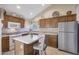 Galley kitchen with wood cabinets, granite island and tile floor at 23635 N 75Th Pl, Scottsdale, AZ 85255