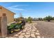 Landscaped backyard with a stone pathway and riding mower at 2697 E Via Del Arboles --, Gilbert, AZ 85298