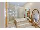 Bathroom with soaking tub, glass block shower, and decorative mirror at 2697 E Via Del Arboles --, Gilbert, AZ 85298