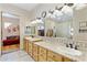 Bathroom with double sinks, large mirror, and access to bedroom at 2697 E Via Del Arboles --, Gilbert, AZ 85298