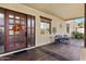 Inviting front porch with a wooden door and comfortable seating area at 2697 E Via Del Arboles --, Gilbert, AZ 85298