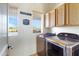 Bright laundry room with washer, dryer and cabinets at 2697 E Via Del Arboles --, Gilbert, AZ 85298