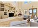 Spacious living room with a fireplace, built-in shelving, and a view of the backyard at 2697 E Via Del Arboles --, Gilbert, AZ 85298