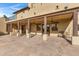 Back patio with stone flooring, covered seating area, and ceiling fans at 2697 E Via Del Arboles --, Gilbert, AZ 85298