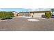Landscaped backyard with gravel and mature trees at 10515 W Oak Ridge Dr, Sun City, AZ 85351