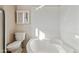 Bathroom with a bathtub, toilet and a small cabinet at 10515 W Oak Ridge Dr, Sun City, AZ 85351
