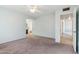 Large bedroom with carpet and access to the hallway at 10515 W Oak Ridge Dr, Sun City, AZ 85351