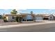 Mid-century modern home with attached garage and desert landscaping at 10515 W Oak Ridge Dr, Sun City, AZ 85351