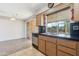 Clean kitchen featuring wood cabinets and stainless steel dishwasher at 10515 W Oak Ridge Dr, Sun City, AZ 85351