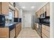 Galley style kitchen with wood cabinets and granite countertops at 10515 W Oak Ridge Dr, Sun City, AZ 85351