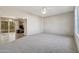 Spacious living room with carpeted floors and access to kitchen at 10515 W Oak Ridge Dr, Sun City, AZ 85351