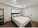 Cozy bedroom with a comfortable bed, wooden floors, white walls, natural light from a bright window at 13050 N 17Th Ave, Phoenix, AZ 85029