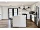 Modern kitchen featuring a large island, stainless steel appliances, white cabinets, and stylish subway tile backsplash at 13050 N 17Th Ave, Phoenix, AZ 85029