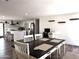 Kitchen and dining area with white cabinetry, stainless steel appliances, and breakfast bar seating at 13050 N 17Th Ave, Phoenix, AZ 85029