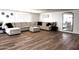 Bright living room with hardwood floors, large sofa, and neutral color scheme is move-in ready at 13050 N 17Th Ave, Phoenix, AZ 85029