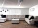 Spacious living room with hardwood floors, and U-shaped couch is designed to be move-in ready at 13050 N 17Th Ave, Phoenix, AZ 85029