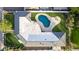 Aerial view of the home, showing the layout, roof, pool, patio, and surrounding green landscape at 1345 W Edgemont Ave, Phoenix, AZ 85007