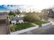 An elevated front view of the property showing the private fence and grassy front yard at 1345 W Edgemont Ave, Phoenix, AZ 85007