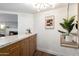 Stylish home bar area with wood cabinetry, marble countertops, and modern lighting at 1345 W Edgemont Ave, Phoenix, AZ 85007