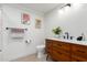 Bright bathroom with modern fixtures, decorative art and floating wooden vanity at 1345 W Edgemont Ave, Phoenix, AZ 85007
