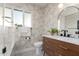 Charming bathroom with palm wallpaper, dark fixtures, and a wood vanity at 1345 W Edgemont Ave, Phoenix, AZ 85007