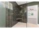 Stunning bathroom shower with custom tile and premium fixtures at 1345 W Edgemont Ave, Phoenix, AZ 85007