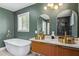 Modern bathroom featuring dual sinks, stylish mirrors, and a freestanding bathtub at 1345 W Edgemont Ave, Phoenix, AZ 85007