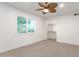 Bright bedroom featuring neutral tones, fan, and a closet at 1345 W Edgemont Ave, Phoenix, AZ 85007