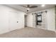 Bedroom with a sliding barn door and a peek into the bathroom at 1345 W Edgemont Ave, Phoenix, AZ 85007