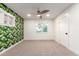 Leafy wallpaper is a feature in this bright bedroom with white walls and neutral carpet at 1345 W Edgemont Ave, Phoenix, AZ 85007