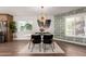 Dining room with a modern chandelier, decorative wallpaper and hardwood flooring at 1345 W Edgemont Ave, Phoenix, AZ 85007