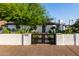 Exterior view of updated home with fresh landscape and updated black fence at 1345 W Edgemont Ave, Phoenix, AZ 85007