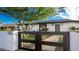 The home's entry featuring a private black gate, stone walkway, and lush green yard at 1345 W Edgemont Ave, Phoenix, AZ 85007