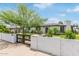 Charming home featuring a black privacy gate, manicured lawn and white painted brick perimeter at 1345 W Edgemont Ave, Phoenix, AZ 85007