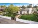 Charming home featuring a black privacy gate, manicured lawn and white painted brick perimeter at 1345 W Edgemont Ave, Phoenix, AZ 85007