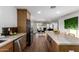 Modern kitchen featuring an open layout, sleek wood cabinets, and updated stainless appliances at 1345 W Edgemont Ave, Phoenix, AZ 85007