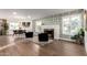 Spacious living room with fireplace, hardwood floors, and light-filled windows at 1345 W Edgemont Ave, Phoenix, AZ 85007