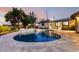 Backyard pool with patio surrounded by greenery and outdoor lighting at 1345 W Edgemont Ave, Phoenix, AZ 85007