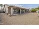 Large backyard with gravel, covered patio, and fruit tree at 14426 W Morning Star Trl, Surprise, AZ 85374