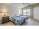 Well-lit bedroom featuring two beds and wood-look floors at 14426 W Morning Star Trl, Surprise, AZ 85374