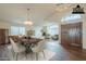 An open-concept dining room with modern lighting and stylish furniture offers a perfect setting for Gathering gatherings at 14426 W Morning Star Trl, Surprise, AZ 85374