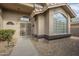 Front entry with decorative iron door and walkway at 14426 W Morning Star Trl, Surprise, AZ 85374